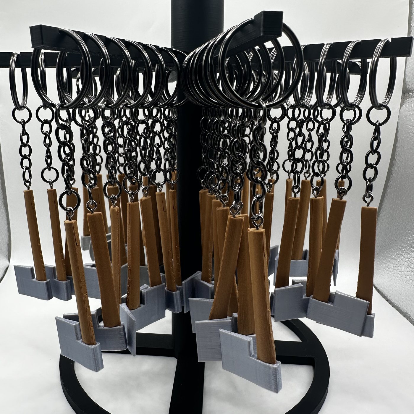 Mini thrower's axe keychains filling a counter display rack