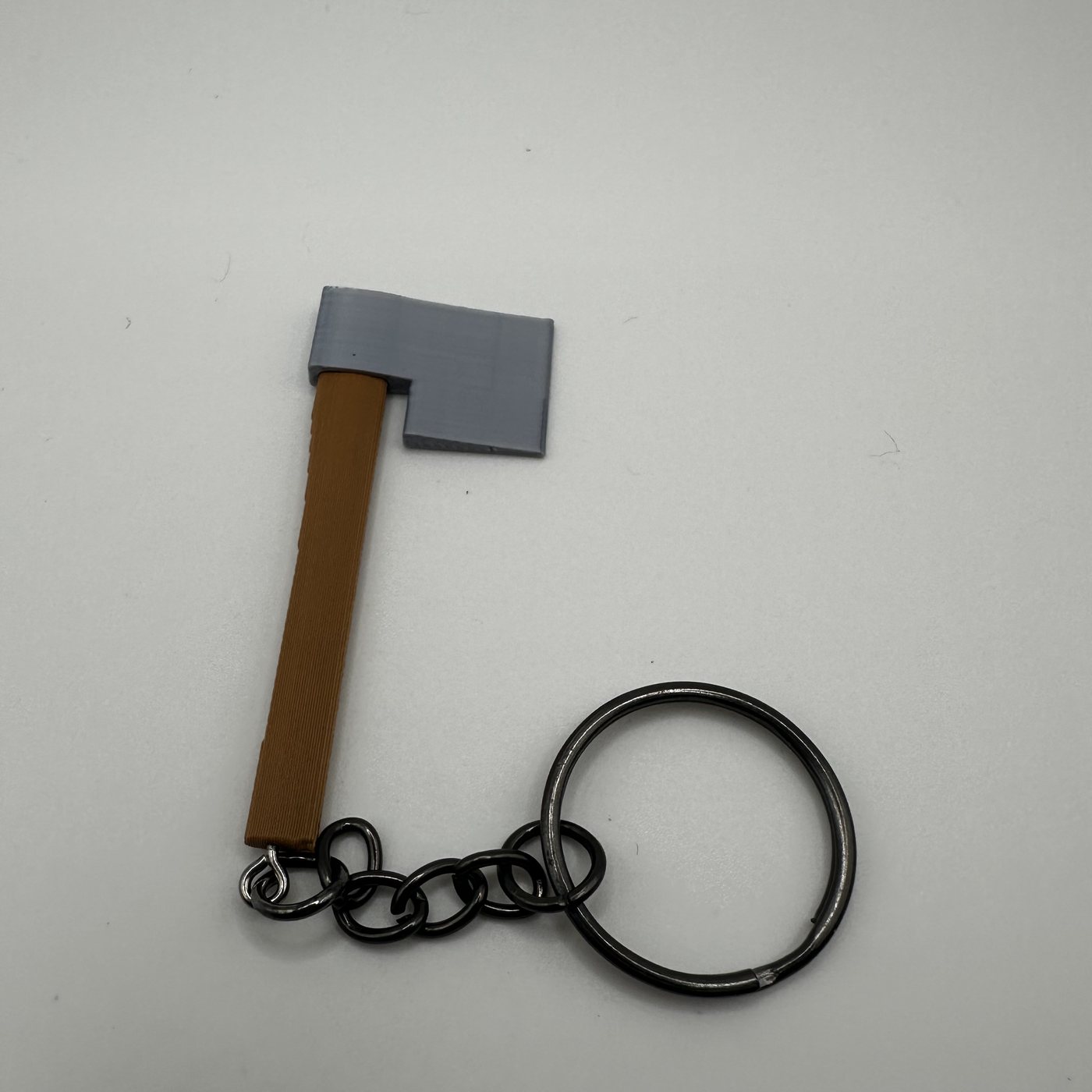 Mini thrower's axe keychain on a split ring